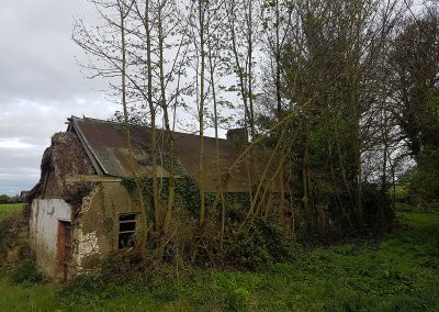 Old tin roofed thatched cottage